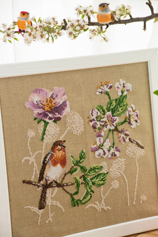 Grille broderie point de croix : Fleurs et rouge-gorge, motif printanier. 129x137 points, 4 pages, couleurs DMC. Lin bis.