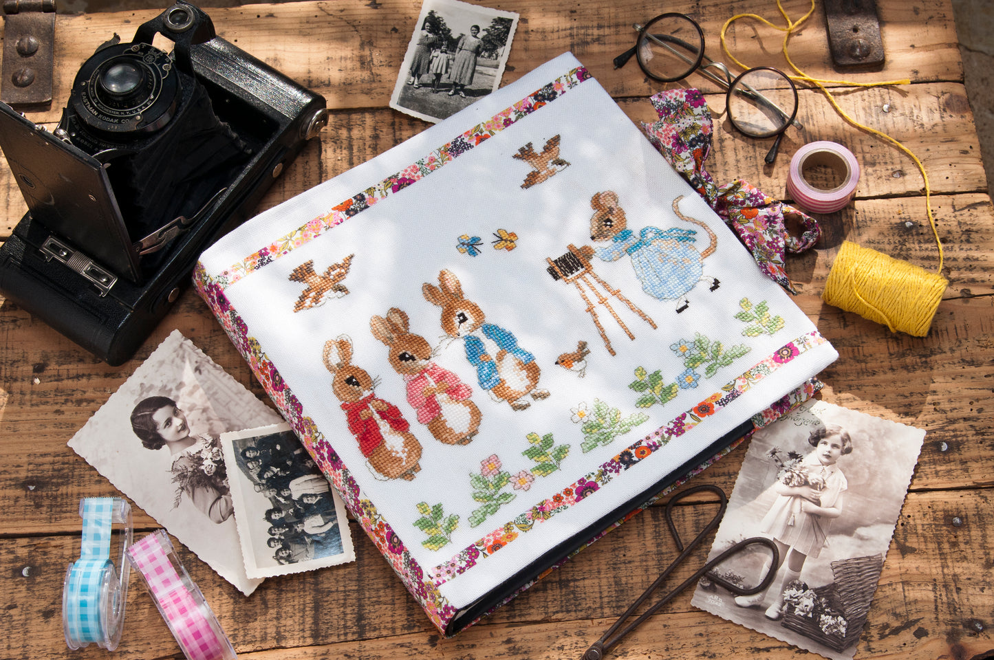 Grille broderie point de croix : album photo naissance Pierrot-Lapin, motif 134×99 pts, 24,4×18 cm. Symboles + couleurs DMC, 6 pages.