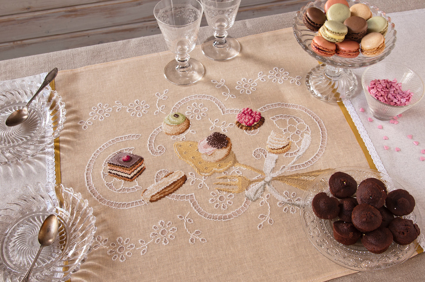 Grille point de croix : chemin de table brodé motifs pâtisseries. 180 x 240 points, imprimée sur 6 pages avec symboles et couleurs DMC. Toile ivoire 12 fils.