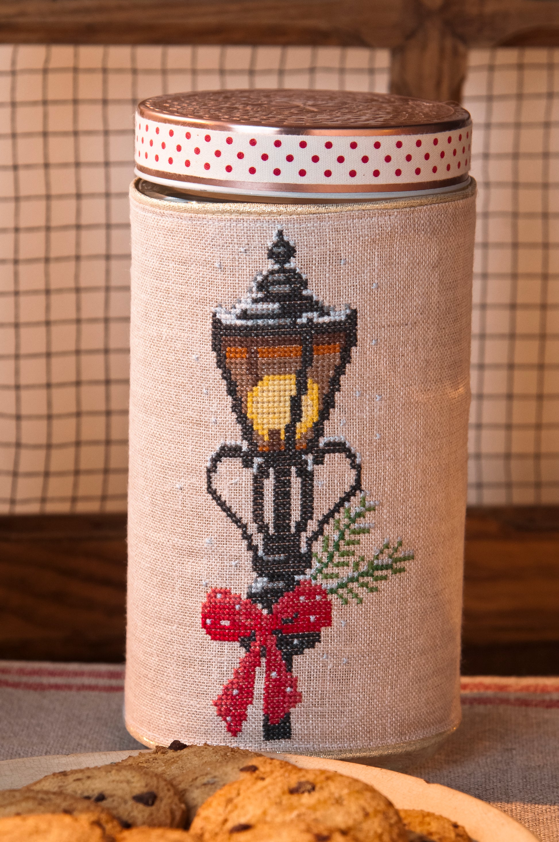 Grille de broderie point de croix : biscuits de Noël sur pots en verre (bougie, branche, réverbère). Imprimé couleur (Réf. DMC) sur 6 pages.