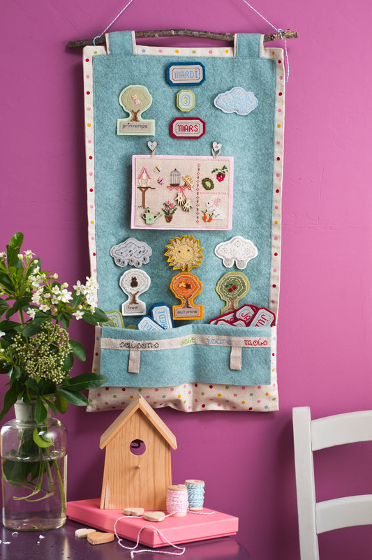 Grille broderie point de croix : calendrier des saisons pour enfants à broder sur lin bis. Par Françoise Dieuzaide, DMC, 8 pages.
