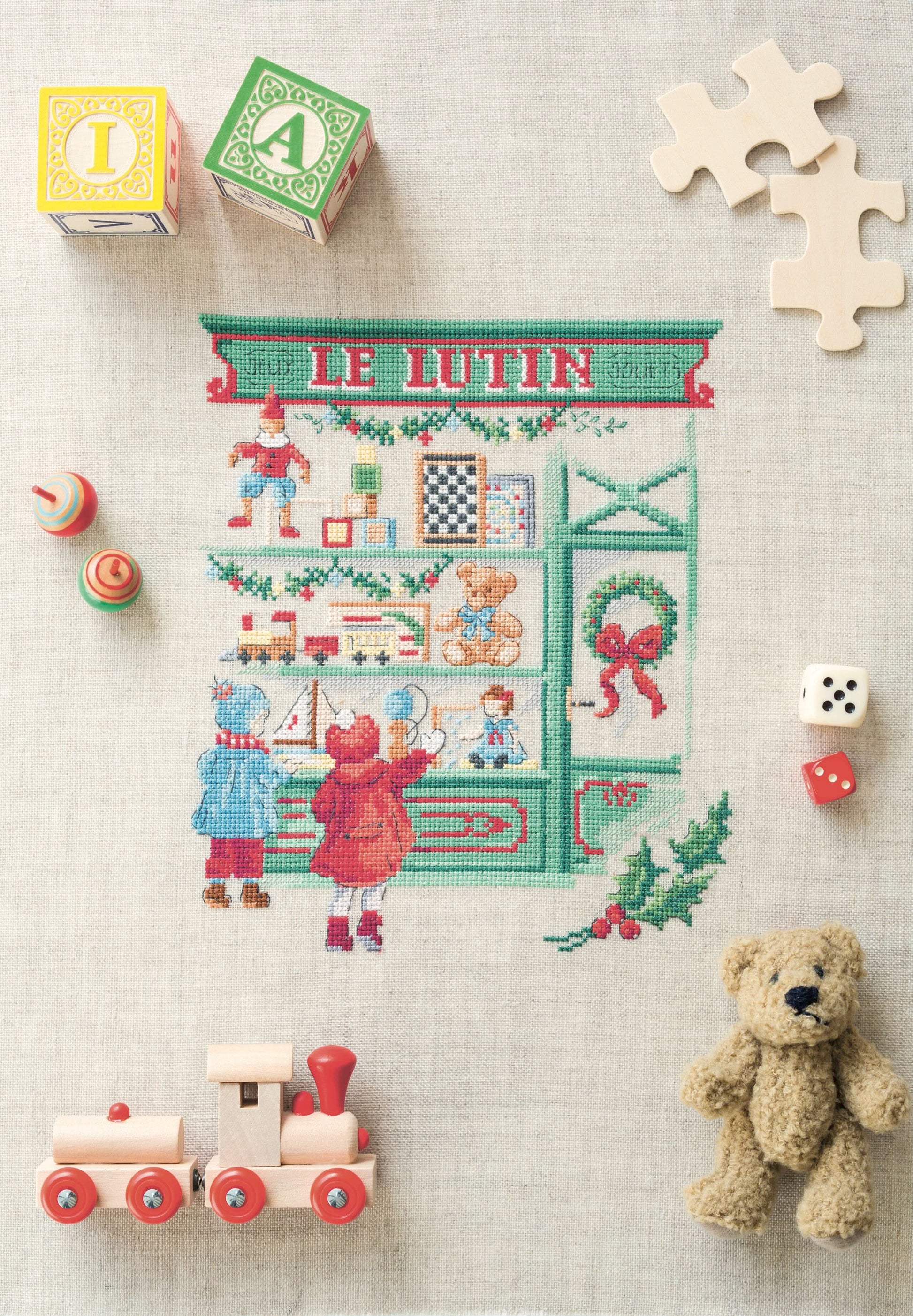 Grille de point de croix La vitrine aux jouets : jouets anciens sur lin 11 fils. 130 x 110 points. Références DMC sur 4 pages.