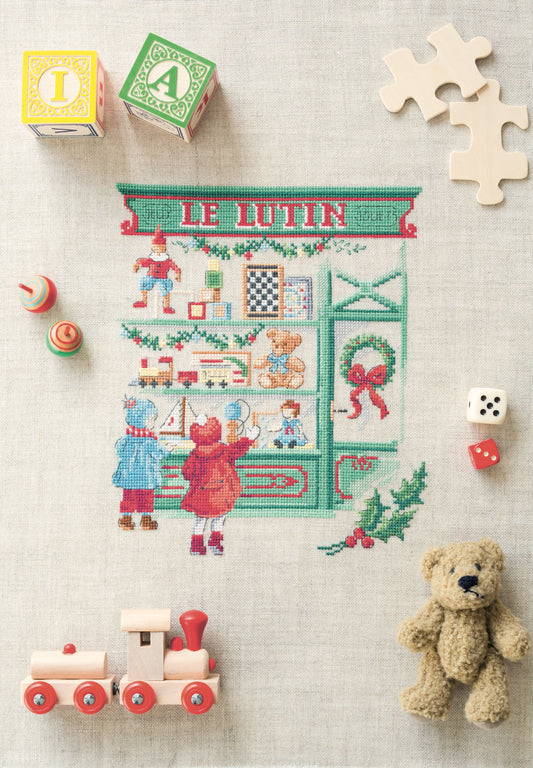 Grille de point de croix La vitrine aux jouets : jouets anciens sur lin 11 fils. 130 x 110 points. Références DMC sur 4 pages.