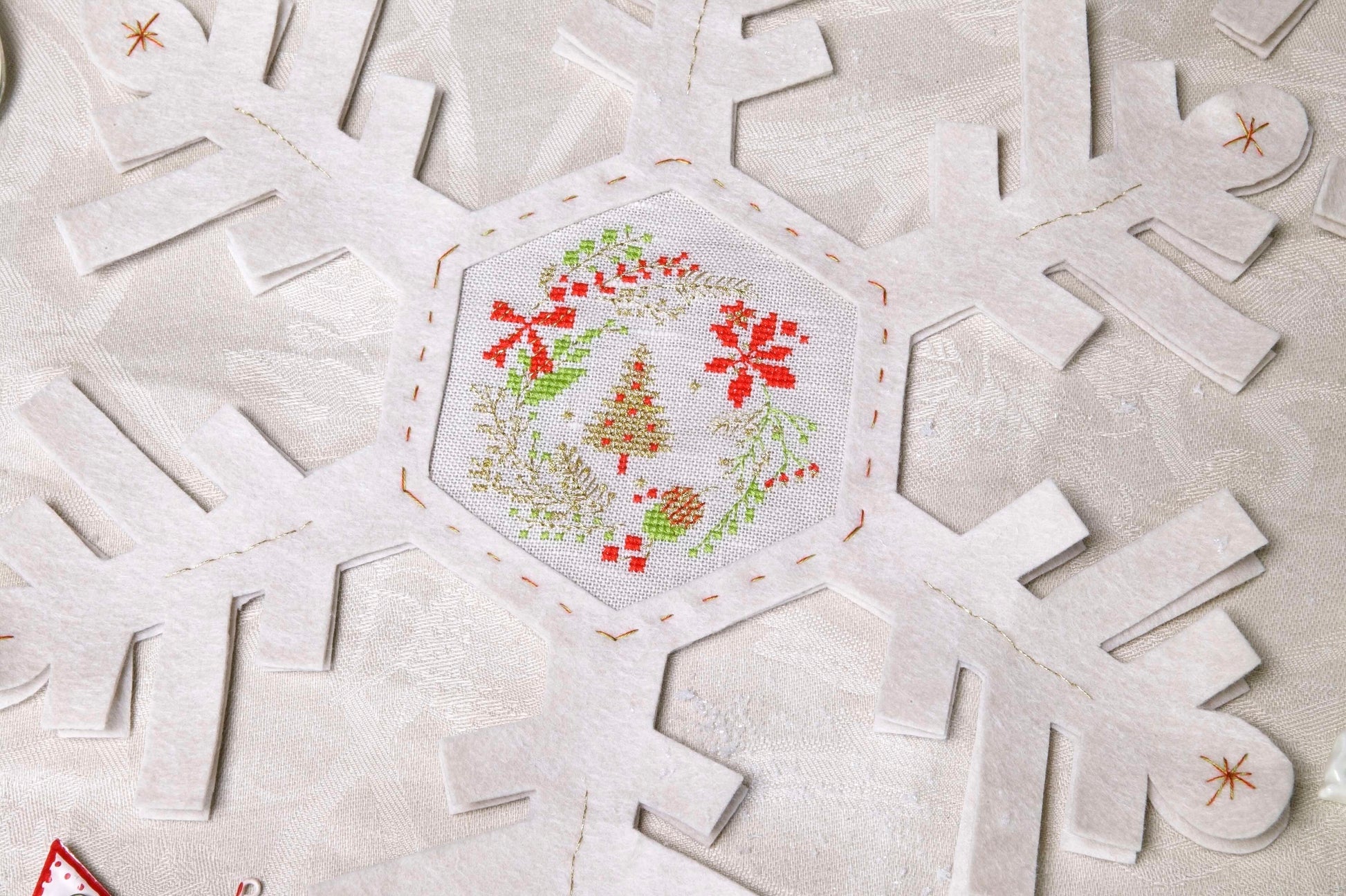 Grille de broderie point de croix : napperon de neige, motifs boule de Noël et sapin sur 4 pages. Symboles et couleurs DMC, sur lin blanc.
