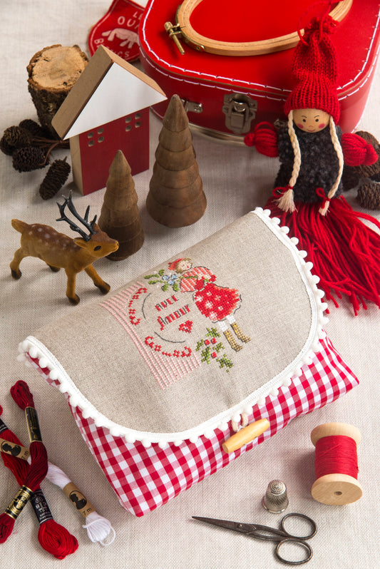 Grille de point de croix Pochette Le charme d'un après-midi enneigé : motifs Noël sur lin bis 11 fils. 54 x 59 points. Références DMC sur 4 pages.