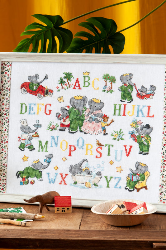 Grille point de croix : tableau ABC de Babar sur lin DMC. Motif 172×138 pts, env. 31×25 cm. Imprimé symboles & couleurs, 6 pages.