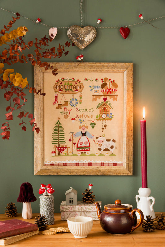 Grille broderie point de croix : scène hivernale au chalet, fermière et vache. 160 x 190 pts, imprimée sur 4 pages. Réf. DMC incluses.