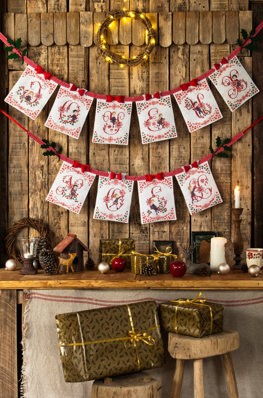 Grille de broderie point de croix « Une banderole Joyeux Noël » par P. Samouiloff : décoration fêtes sur toile blanche 11 fils. DMC, 6 pages, motif 14,54 x 18,18 cm.